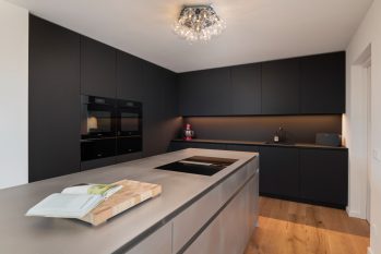 Moderne mat zwarte Mereno keuken met RVS eiland